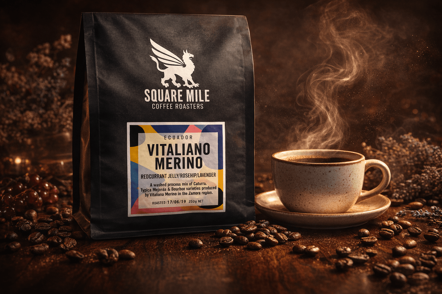 Square Mile coffee bag beside a steaming cup of coffee and scattered roasted beans.